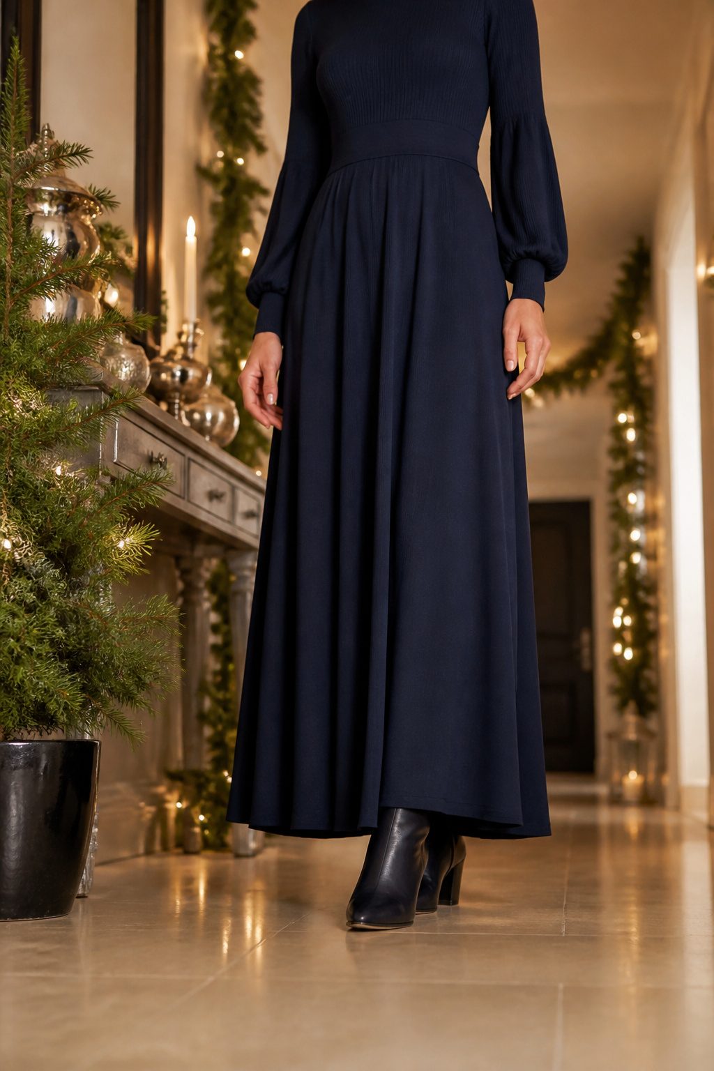 A long sleeve navy knit maxi dress in a winter setting.