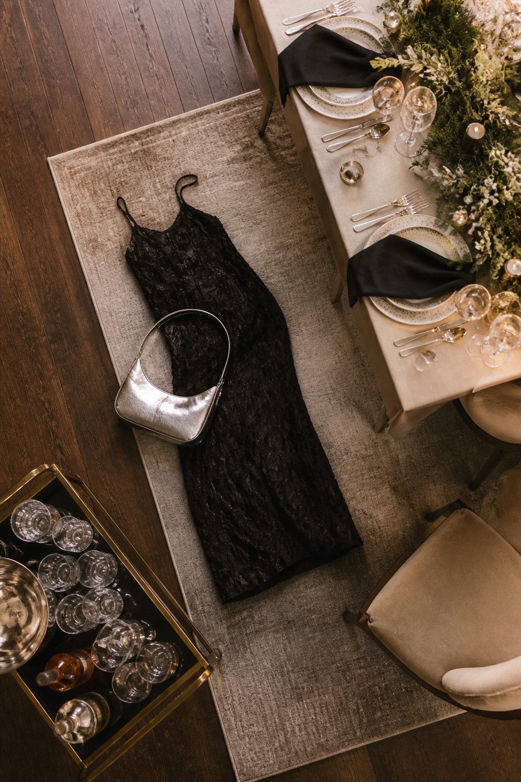 A silver bag alongside stacked bangles in a festive setting.