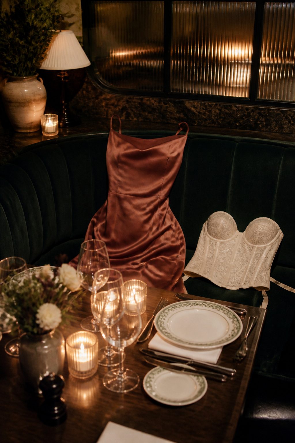 Satin mini dress displayed next to a plush restaurant booth.