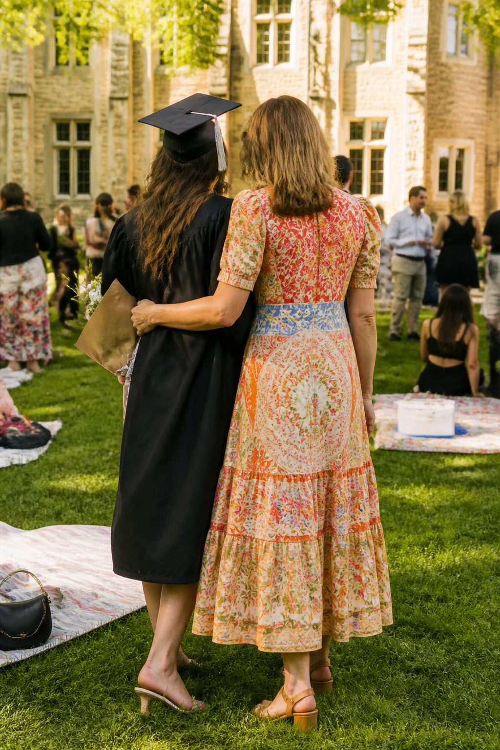 A woman in the Farm Rio x Anthro Midi Dress in a lively courtyard.