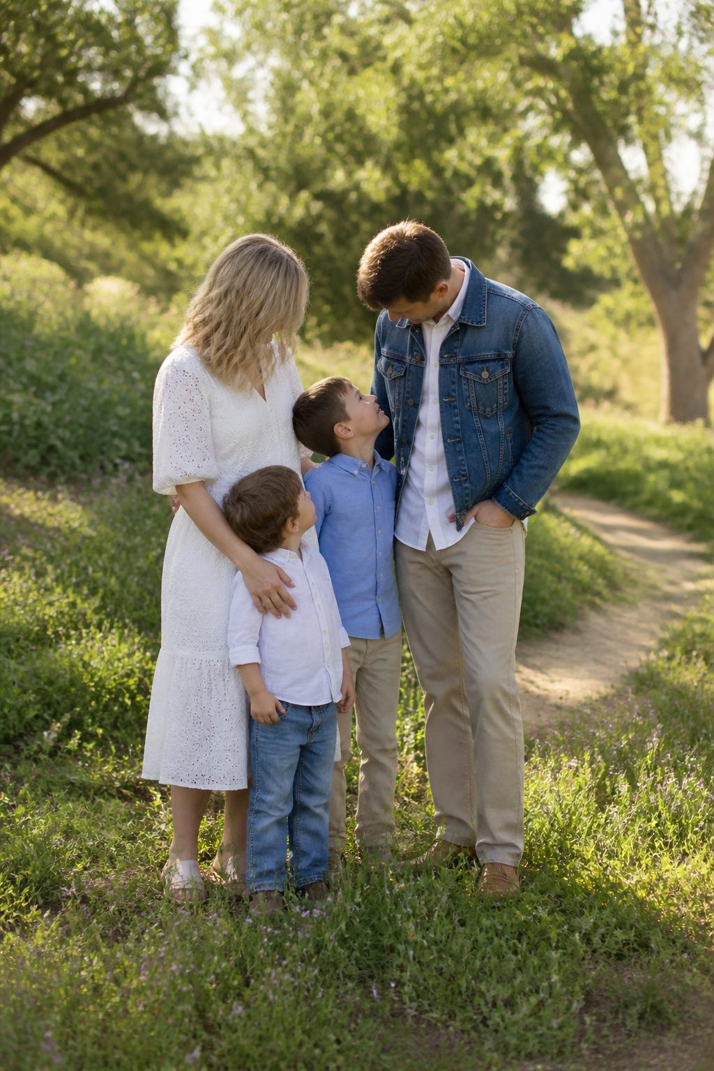 Family in denim and white outfits, featuring a white eyelet dress.