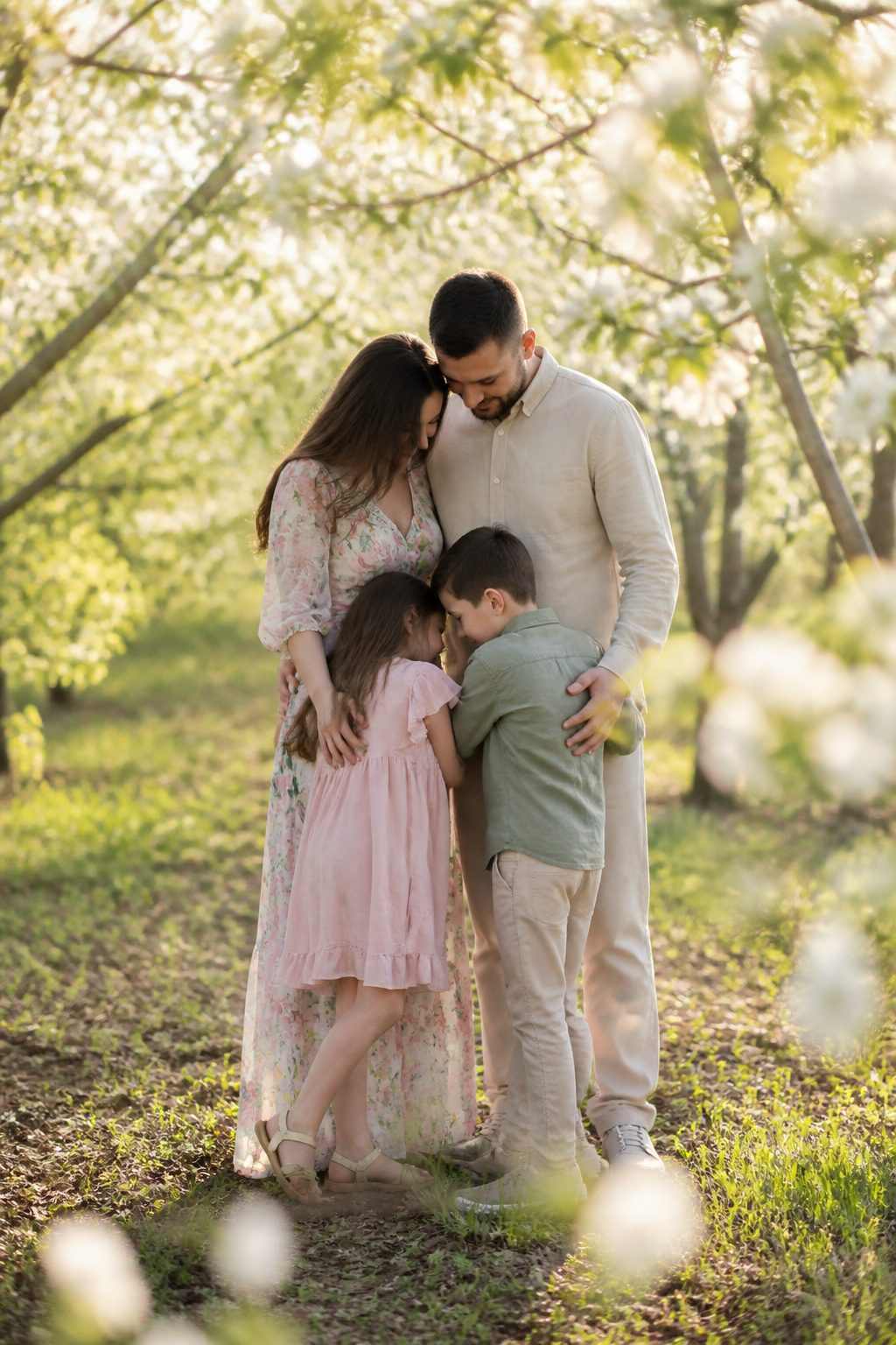 Family dressed in floral and solid outfits in a vibrant setting.